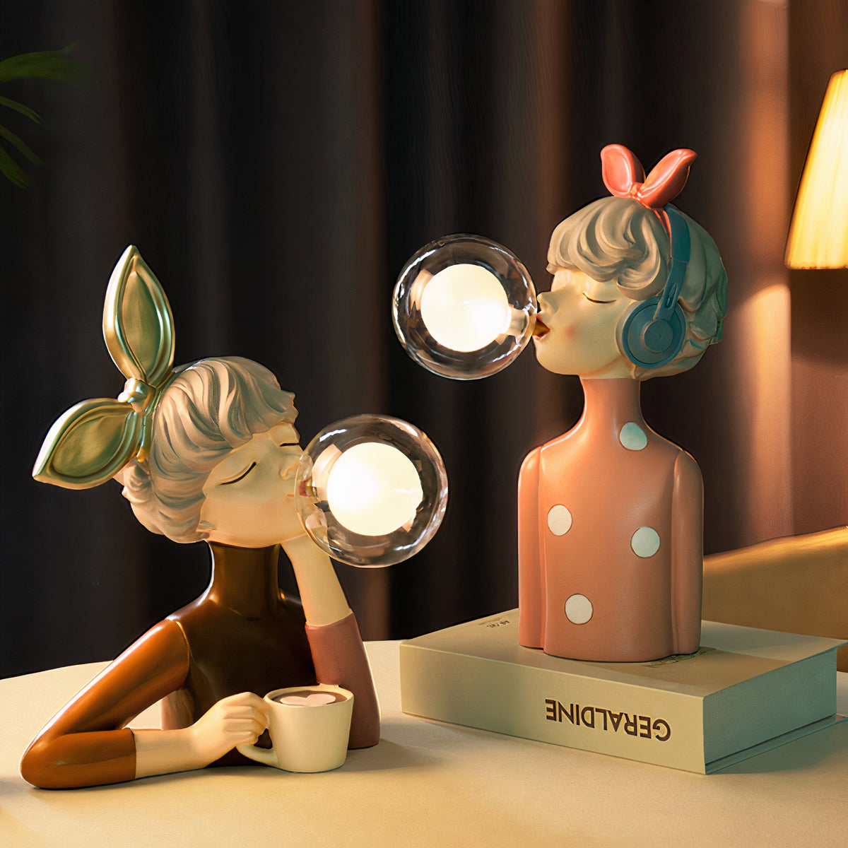 Two USB table lamps glowing on a table beside a book