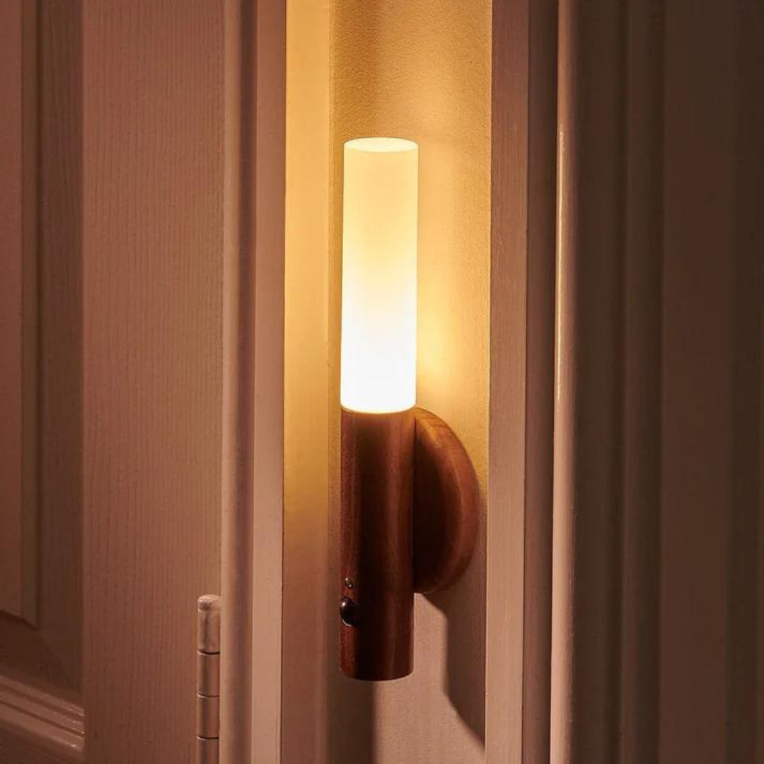 LED torch light glowing warmly on a wall beside a door