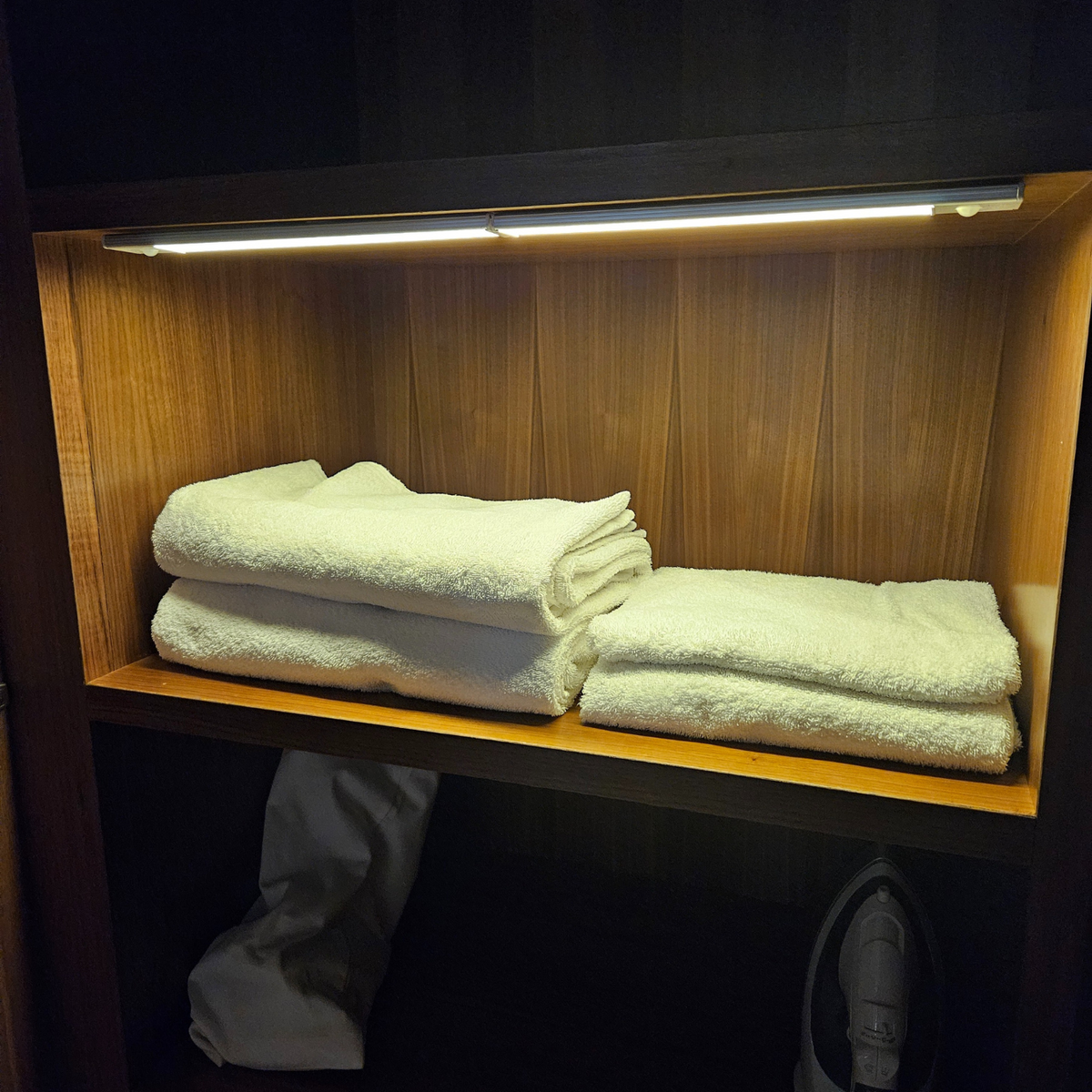 LED light bar for home inside a closet above folded towels