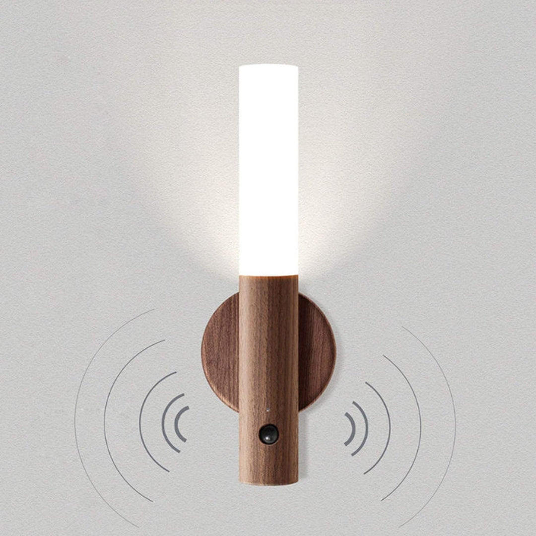 Motion sensor LED torch with faux-wood handle on gray wall