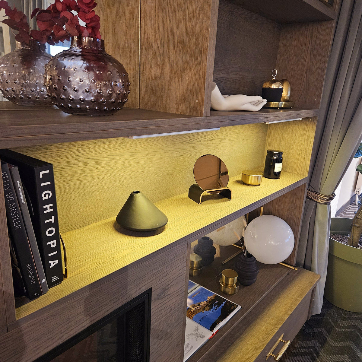 LED bar light casting warm glow on decor shelves