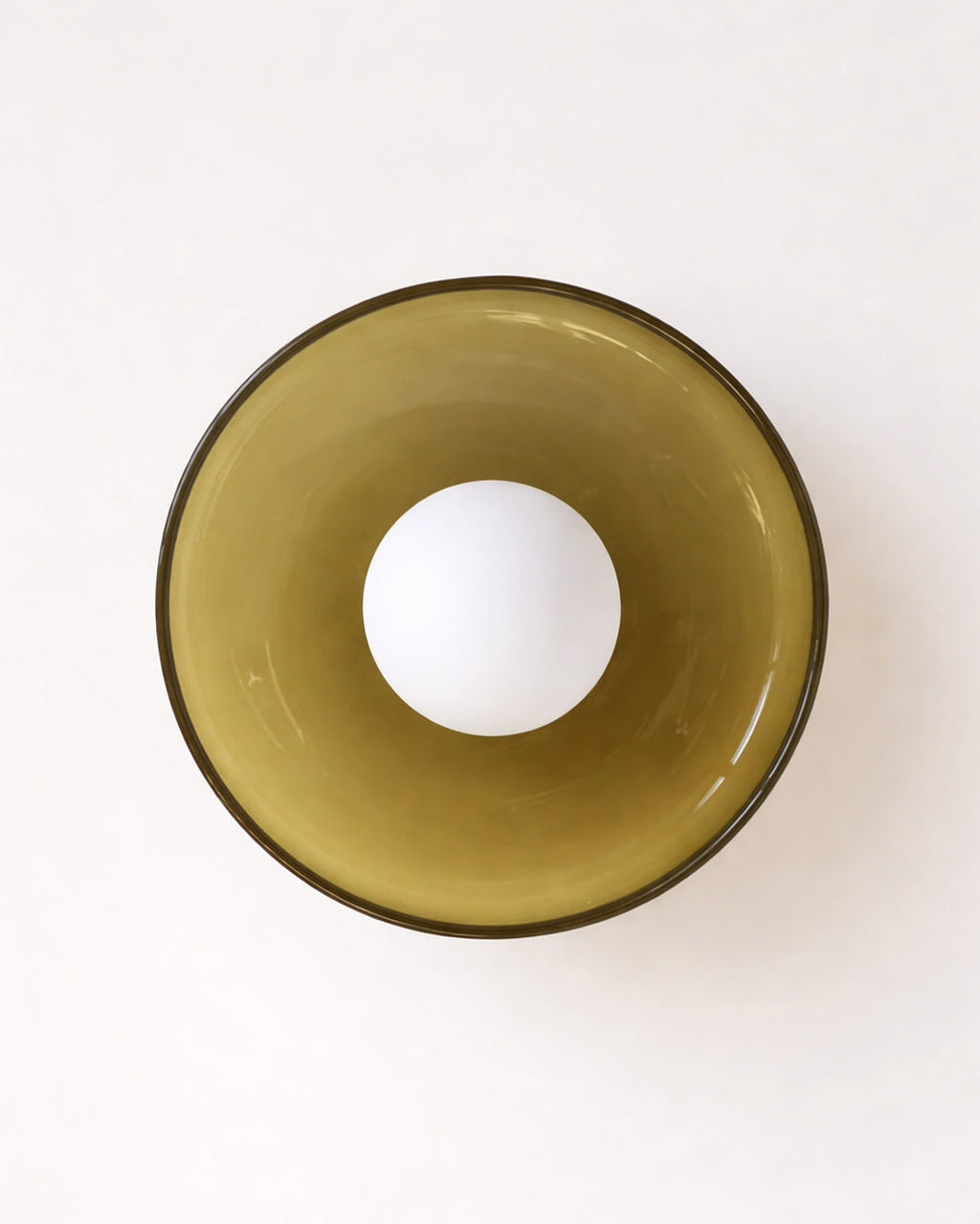 Round glass wall light fixture with white globe bulb