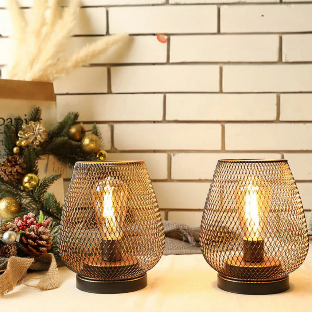 Small table lamps glowing beside pine branches and pinecones
