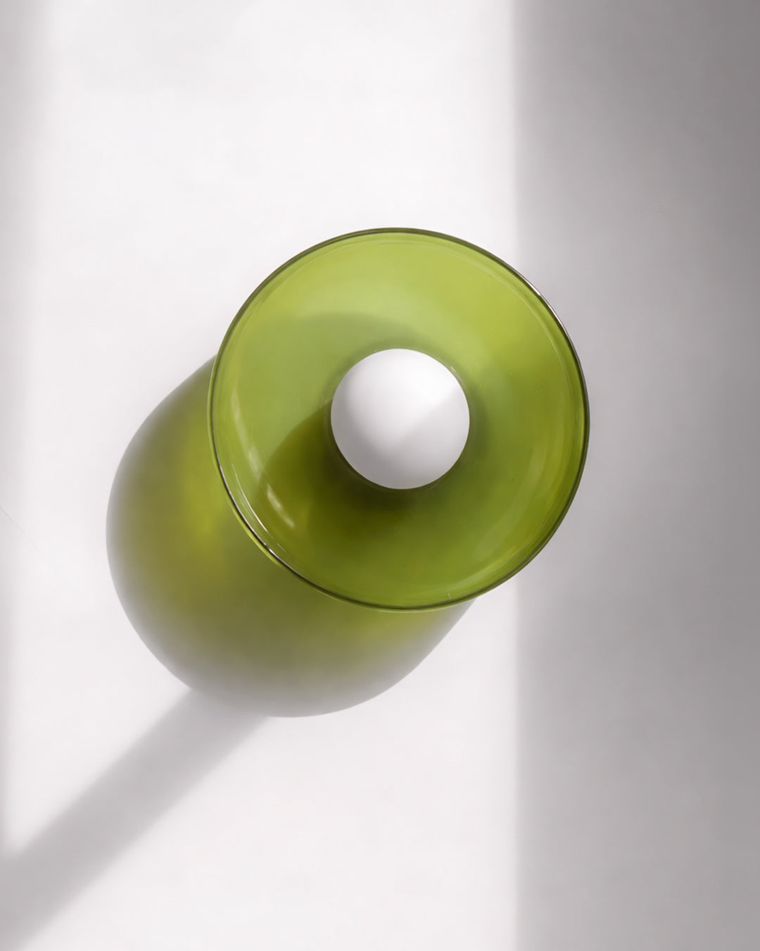 Circular glass wall and ceiling light in a modern room