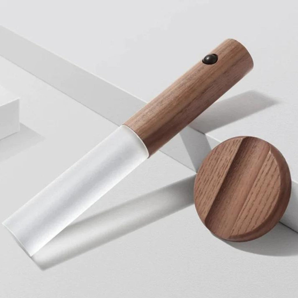 Removable LED torch beside its round faux-wood wall mount
