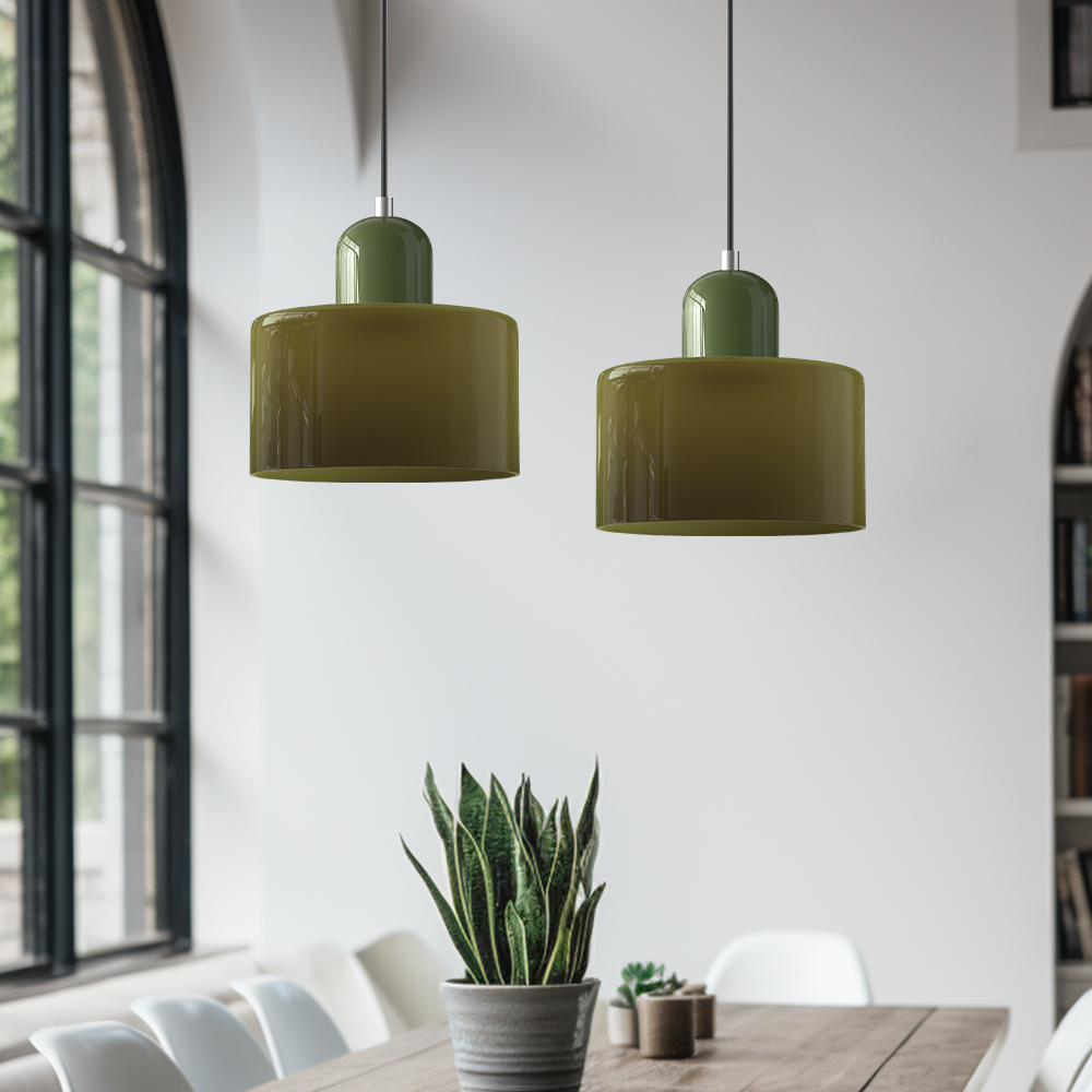 Pair of green hanging ceiling lights above a wooden dining table