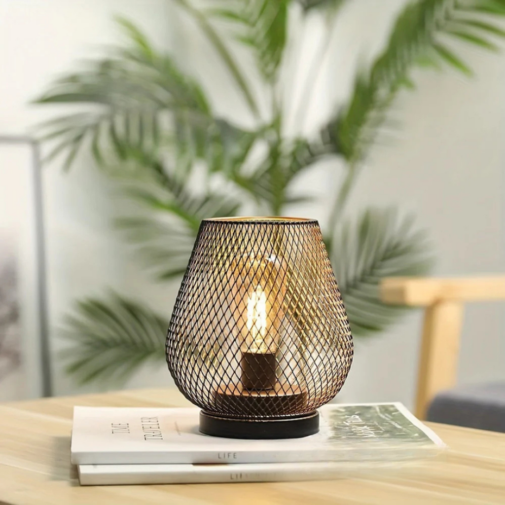 Single cordless table lamp on books in a bright living room