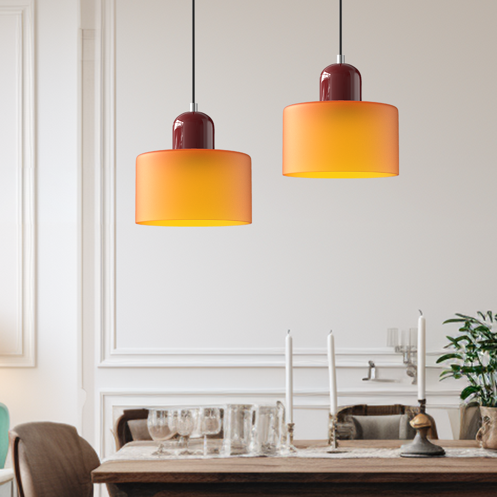 Two orange glass pendant lights as dining table lights