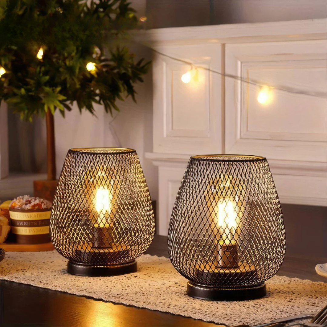 Battery table lamps on a lace table runner by string lights