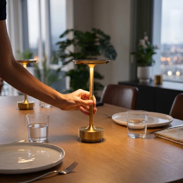 Hand placing a gold touch table lamp on a dining table