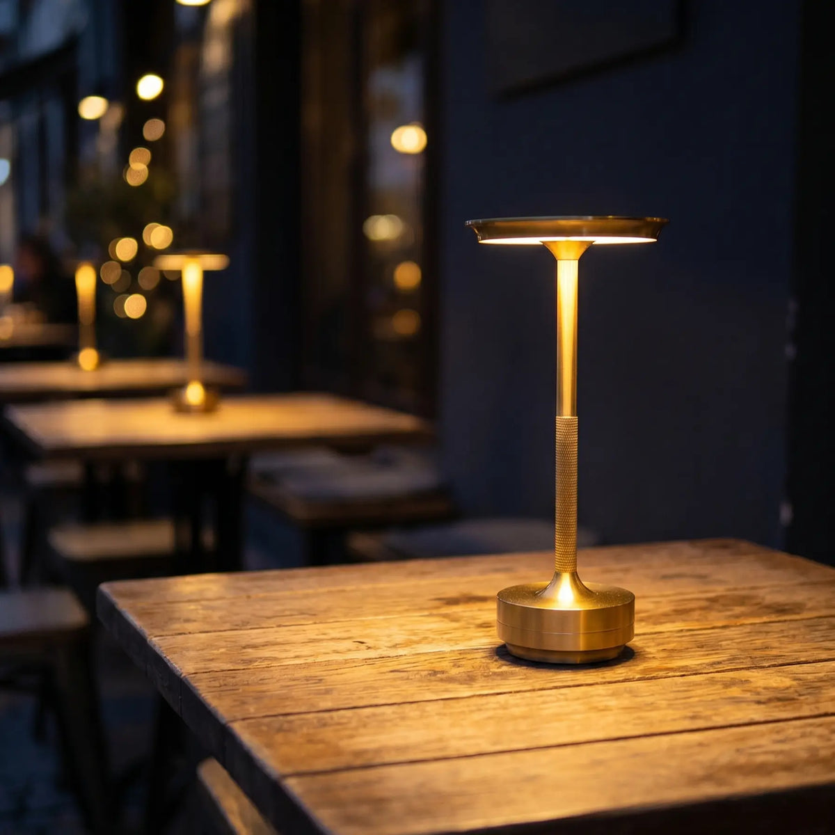 Gold dining table lamp casting a warm pool of light