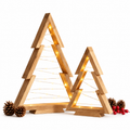 Two wooden mini Christmas trees glowing with warm LED lights