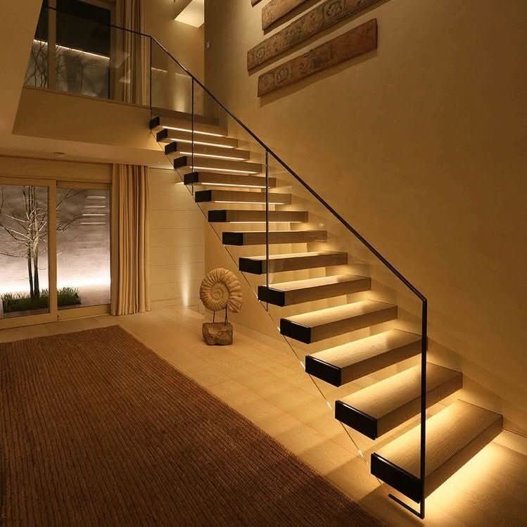 Staircase lit by warm LED step lights at night