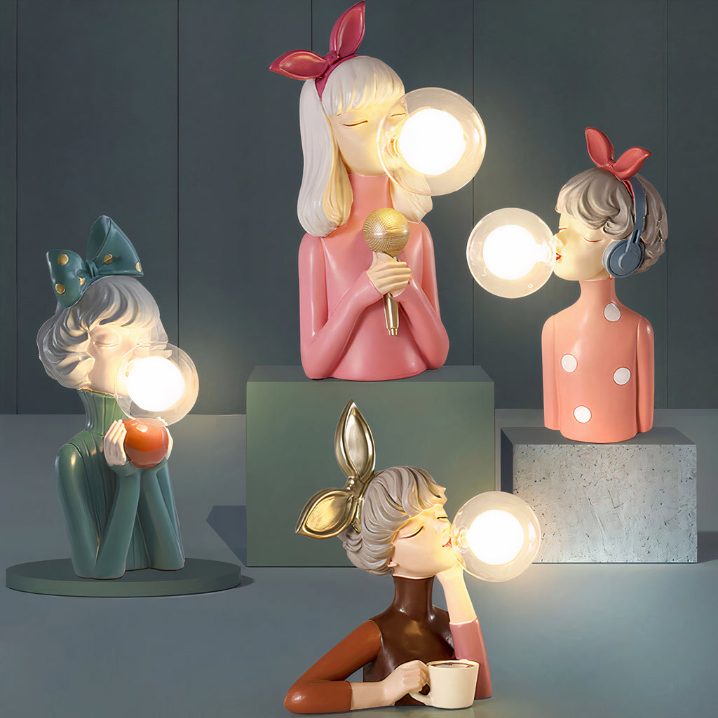 Four resin figure lamps with glass bubble shades on display blocks