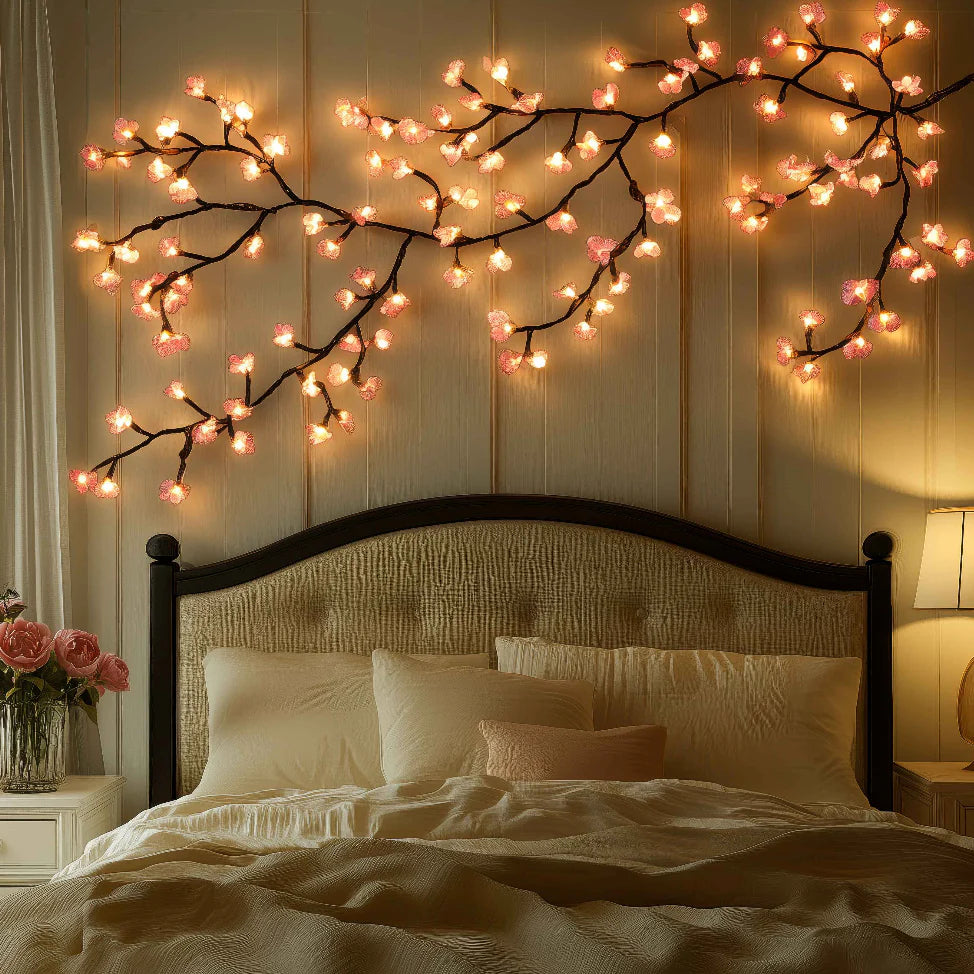 Blossom LED wall lights spread wide above a padded headboard