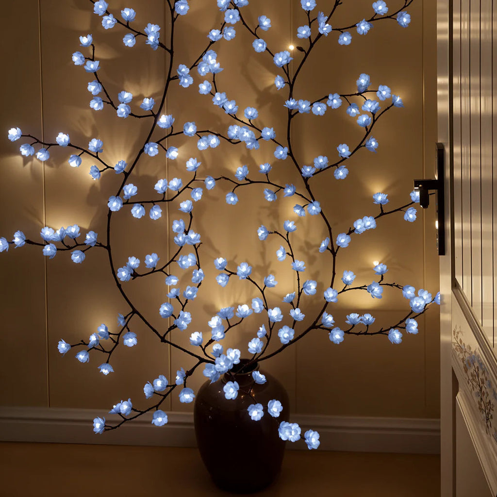 Iced Blossom faux branch wall lights glowing softly at night