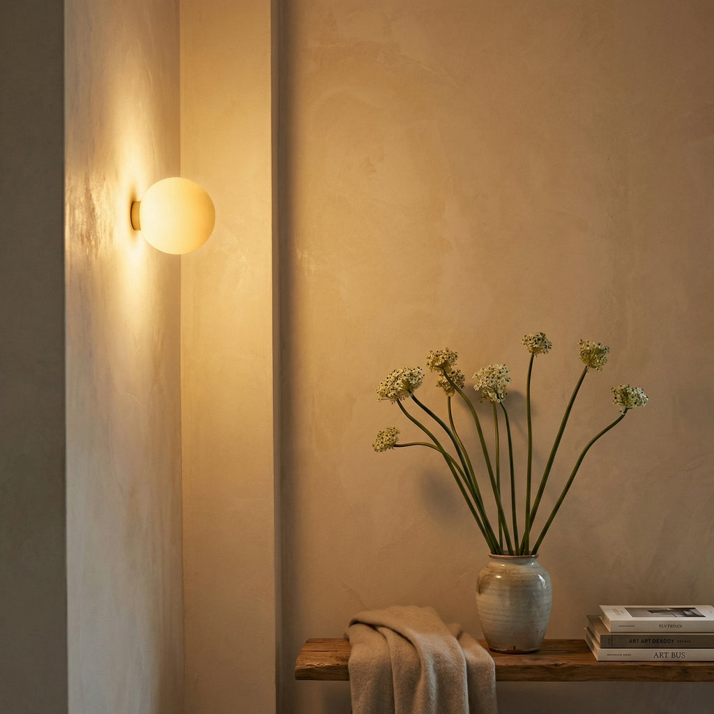 Globe sconce beside mirror