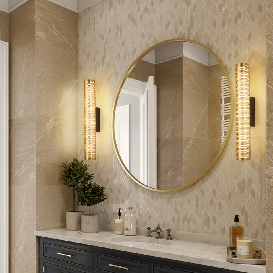Gold vanity light beside mirror