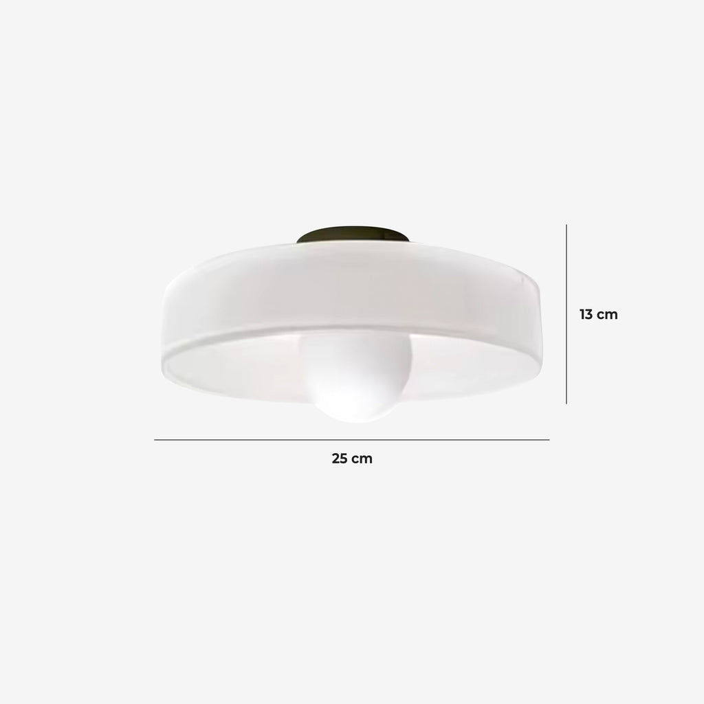 Circular glass wall light in a bedroom setting