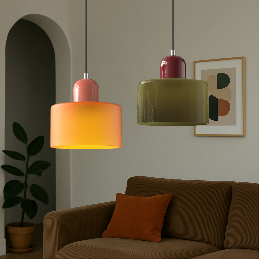 Orange and green glass pendant lights over a corduroy sofa
