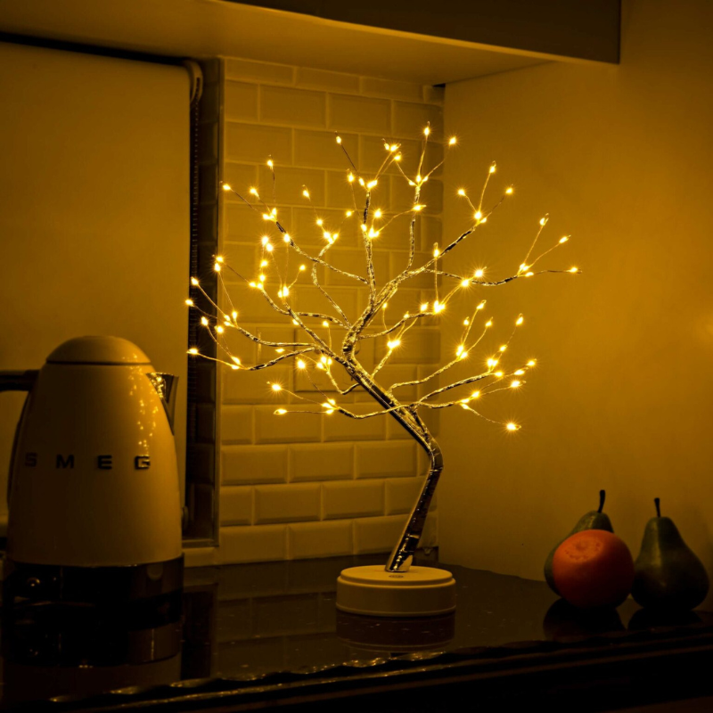 Bonsai tree LED lamp glowing warm white on a kitchen counter