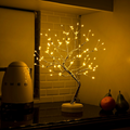 Bonsai tree LED lamp glowing warm white on a kitchen counter