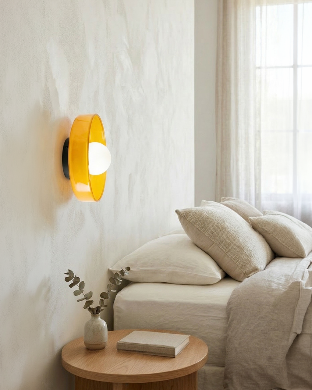 Orange retro wall light glowing beside a linen bed