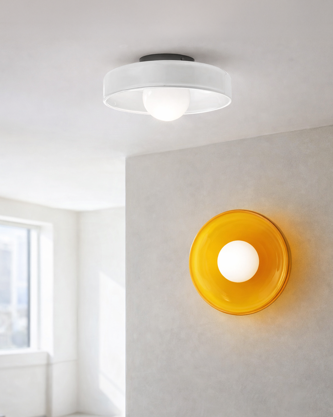 White glass ceiling light and orange wall light fixture in bright room