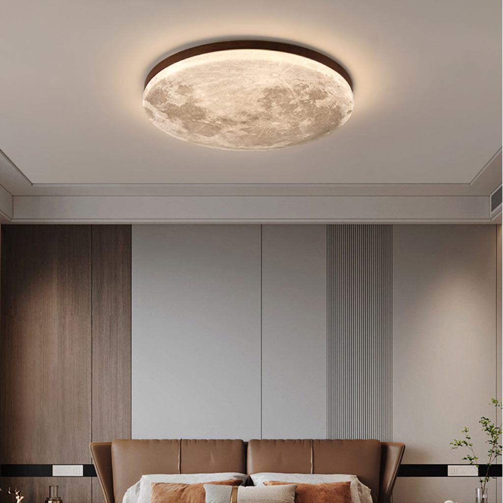 Moon ceiling light with dark wood rim above a leather bed