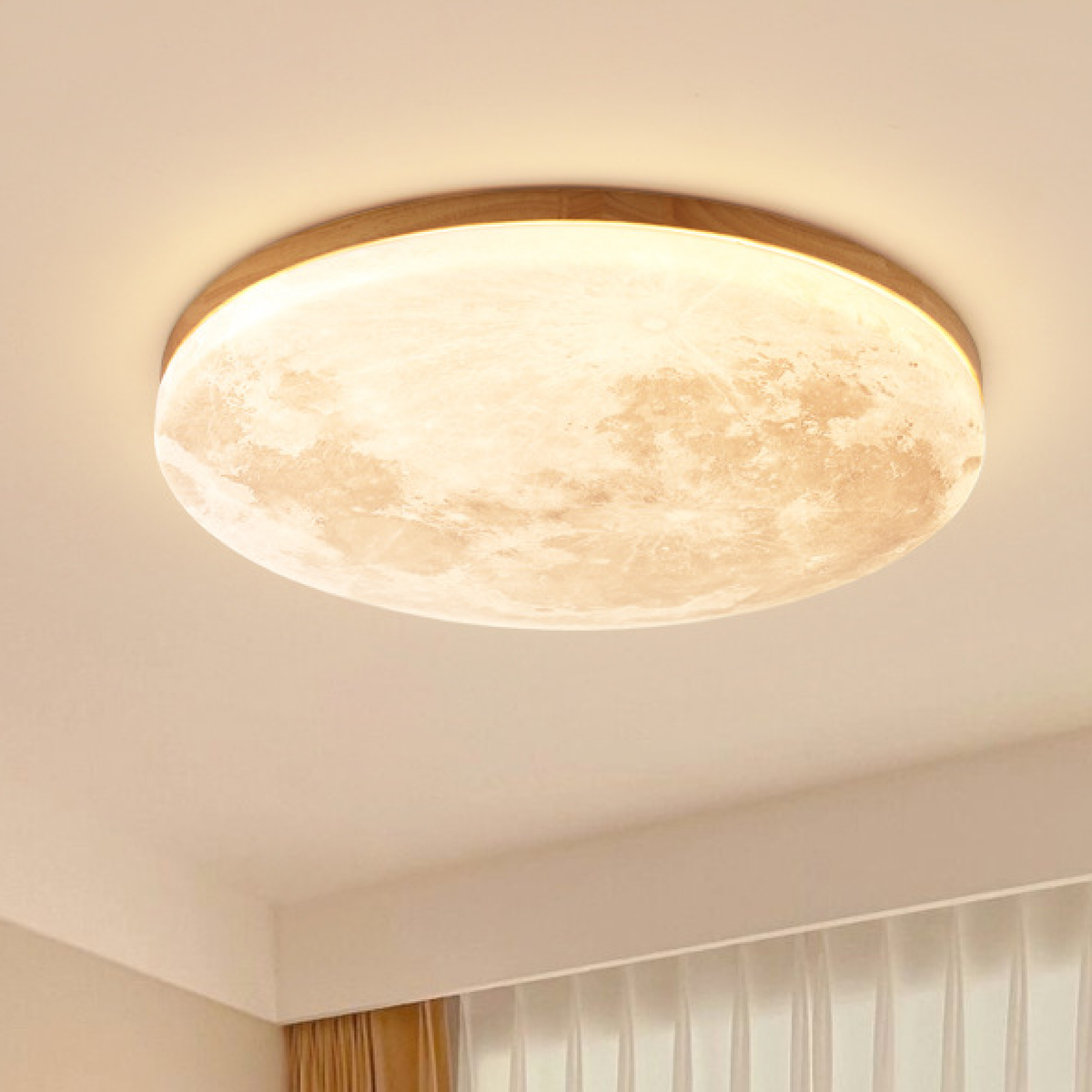 Moon LED ceiling light with light wood rim glowing warm white
