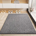 Gray absorbent doormat on herringbone floor by a shower