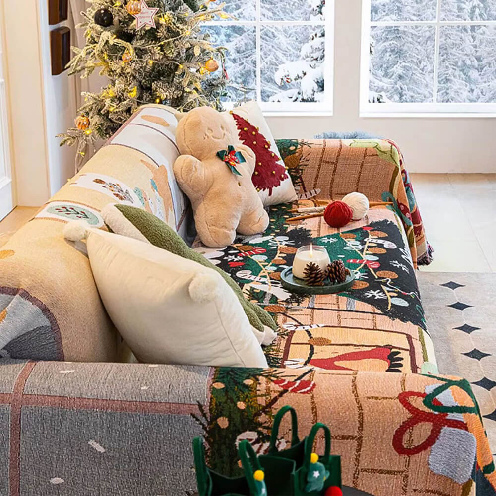 Fireside Christmas sofa cover beside a snowy window and tree