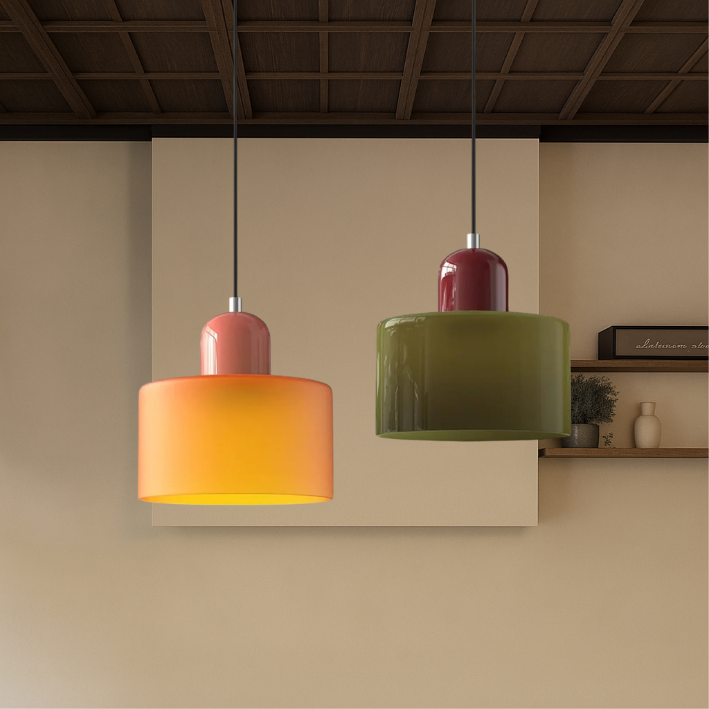Colored glass pendant lights hanging against a warm beige wall
