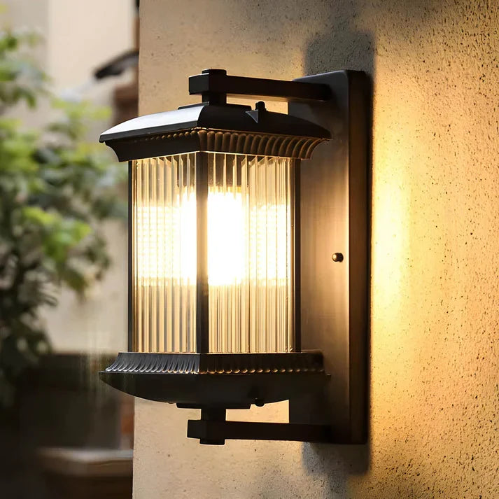 Close-up of fluted glass outdoor wall sconce in warm light