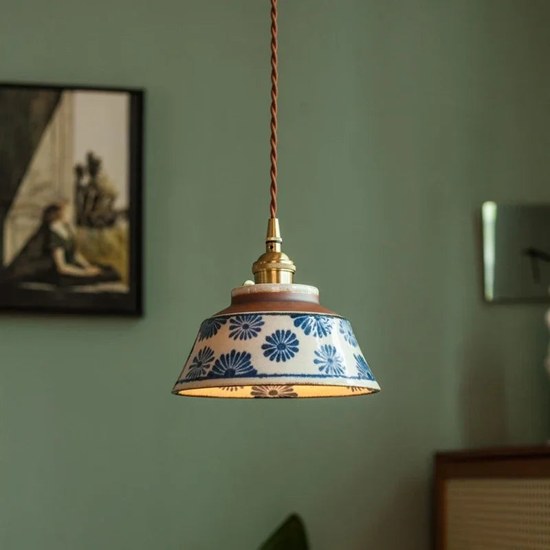 Hand-painted ceramic pendant light over a dining table