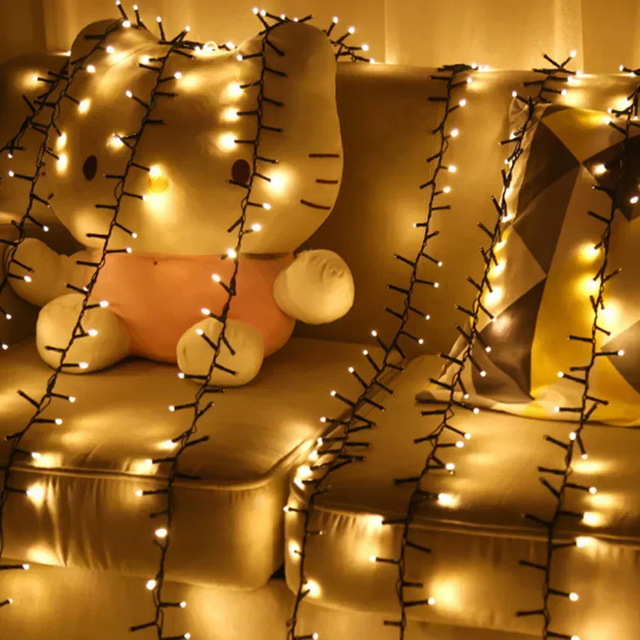 Long string Christmas lights draped over a cozy sofa