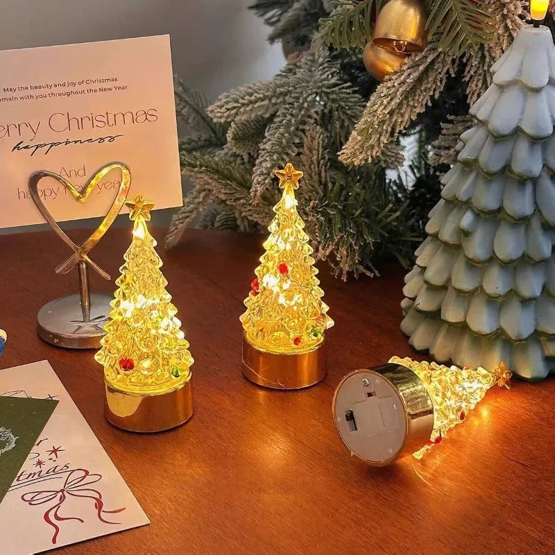 Three battery operated Christmas tree lamps on a wooden desk