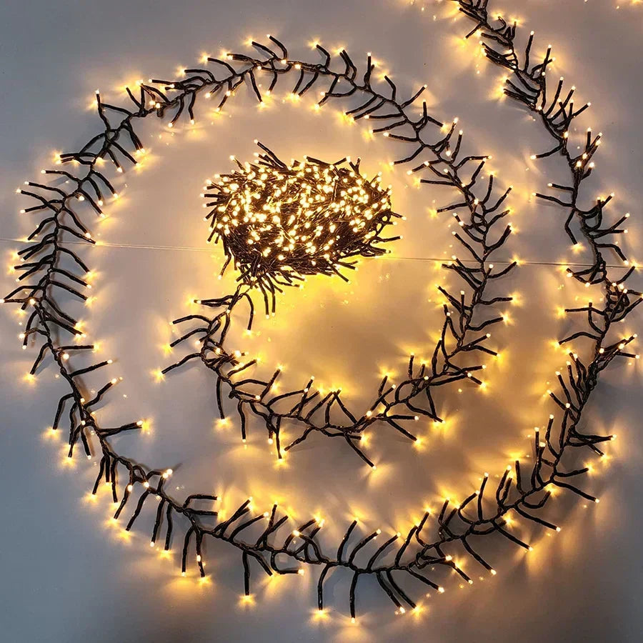 Warm white cluster string Christmas lights coiled in a glowing spiral