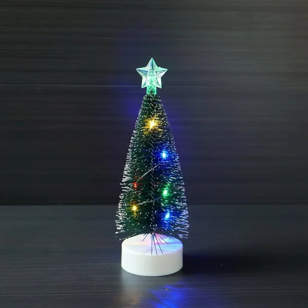 Christmas tree with colored lights on a white base