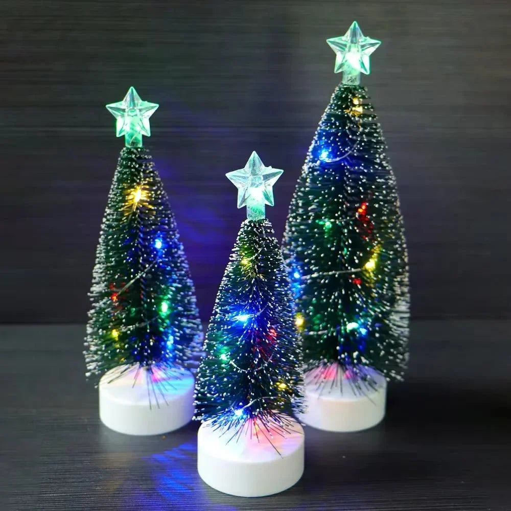 Small battery operated Christmas tree glowing on a shelf