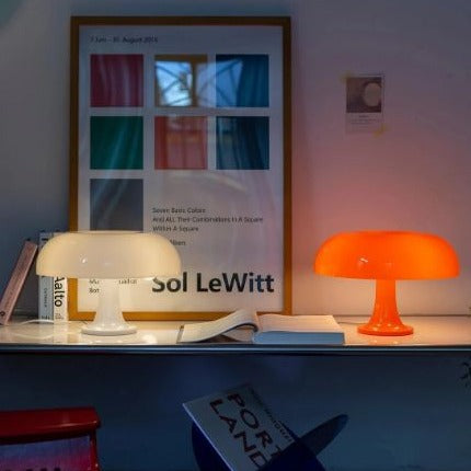 White and orange mushroom lamps glowing on a living room shelf