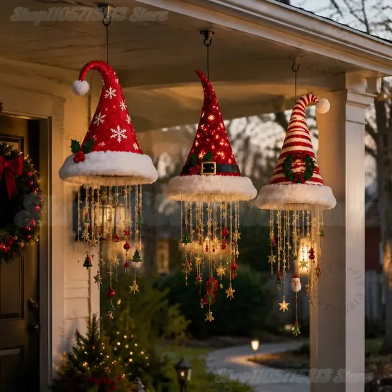 Three lighted Christmas hats hanging along a front porch