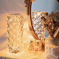 Touch table lamp glowing on a dresser beside a gold mirror
