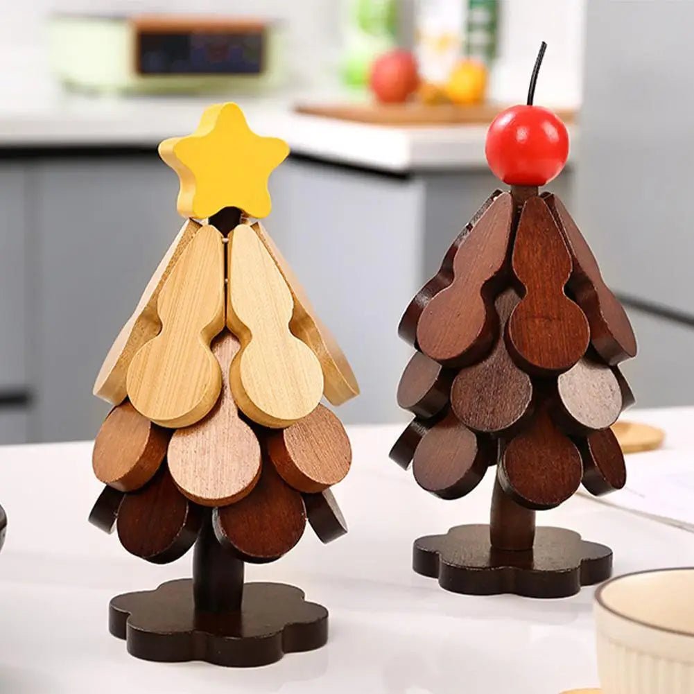 Two wooden Christmas tree trivets on a kitchen counter