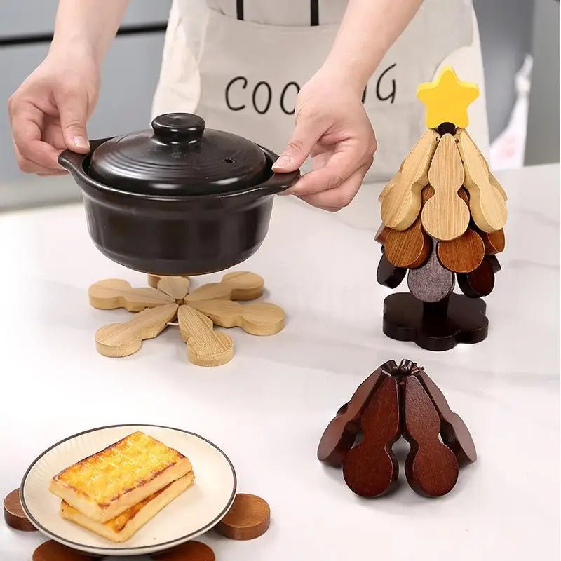 Unfolded wooden trivet under a hot pot beside tabletop tree