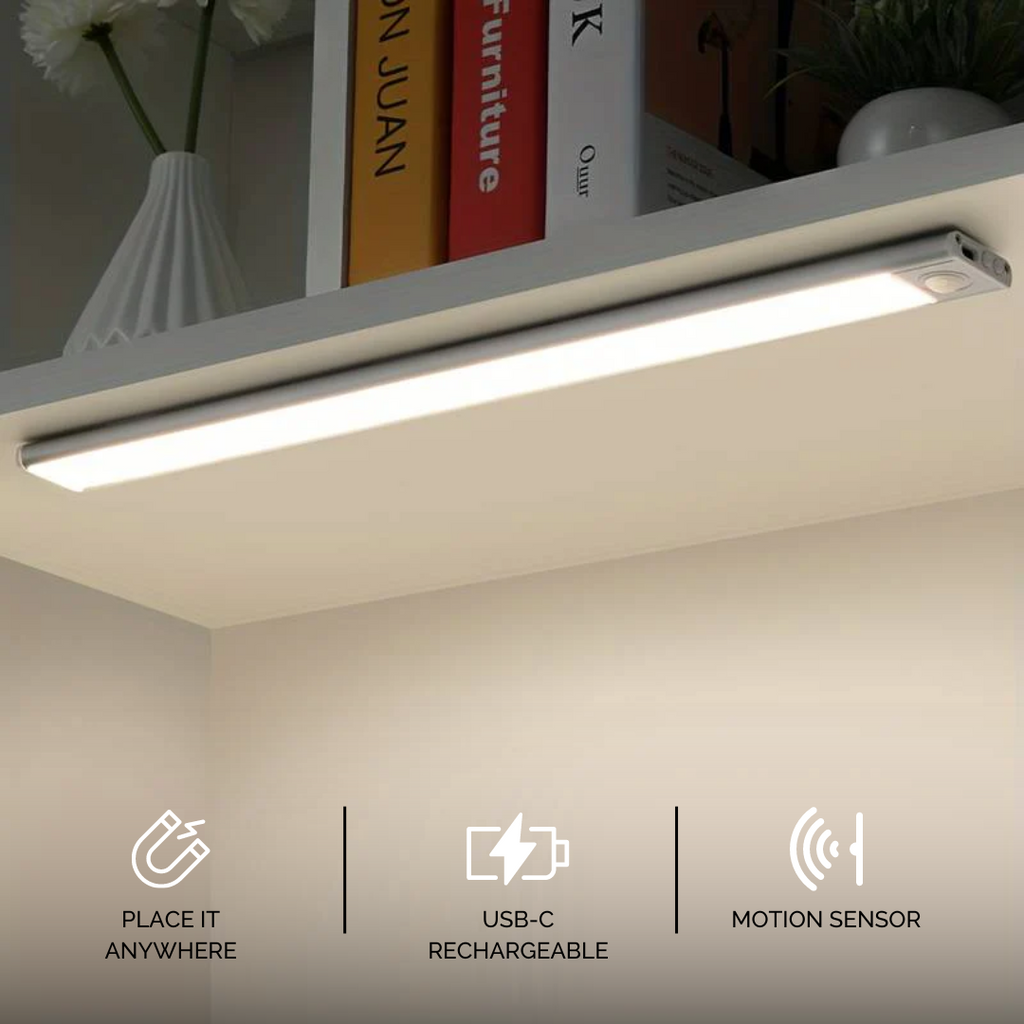 LED bar light glowing warm under a white bookshelf