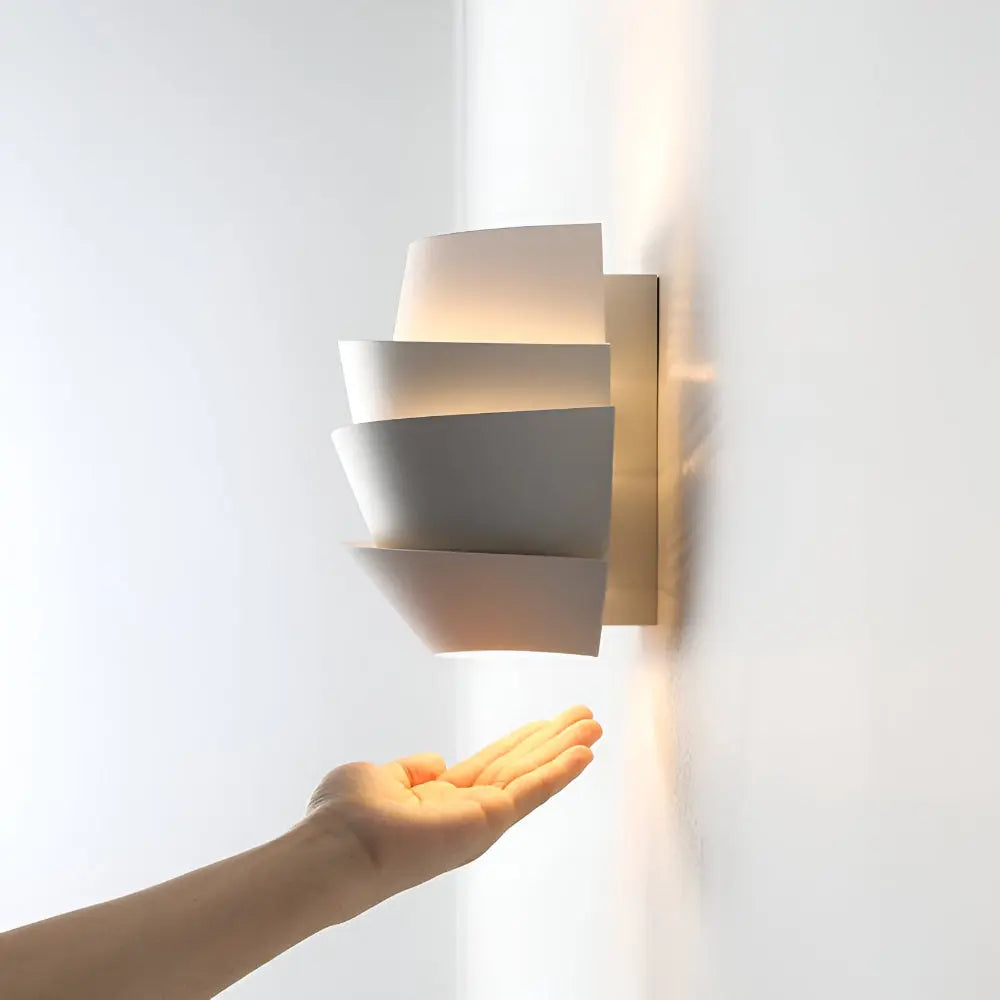 Side view of iron wall light fixture with layered shade