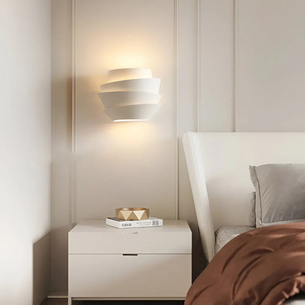 Layered white wall sconce with soft up and down glow