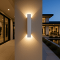 White LED wall light casting a warm up-and-down glow at dusk