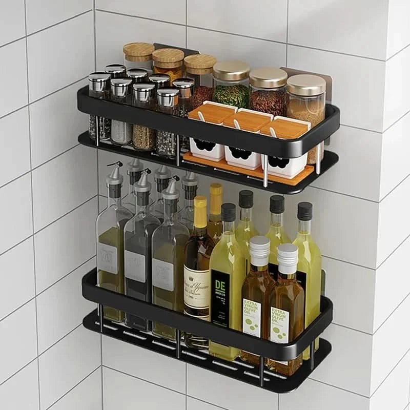 Two black wall shelves holding spice jars and oil bottles